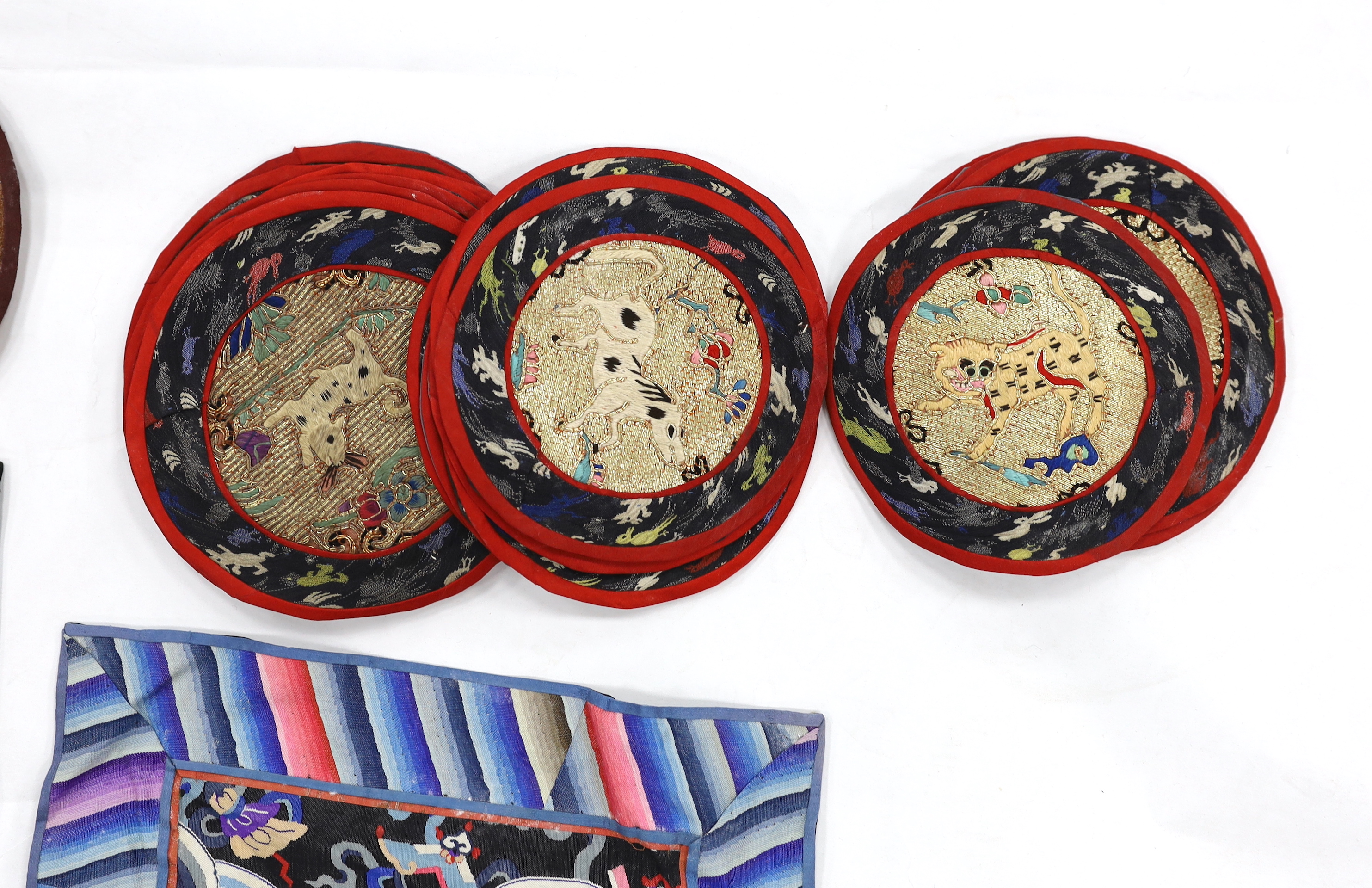 A Kesi Chinese woven panel, a Beijing knot mat, two other embroidered panels, a circular mat together with two sets of six circular mats with gold thread embroidery of animals